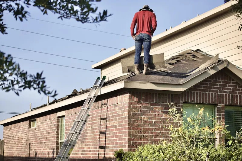 Professional roofer working on a residential roof in Siesta Key